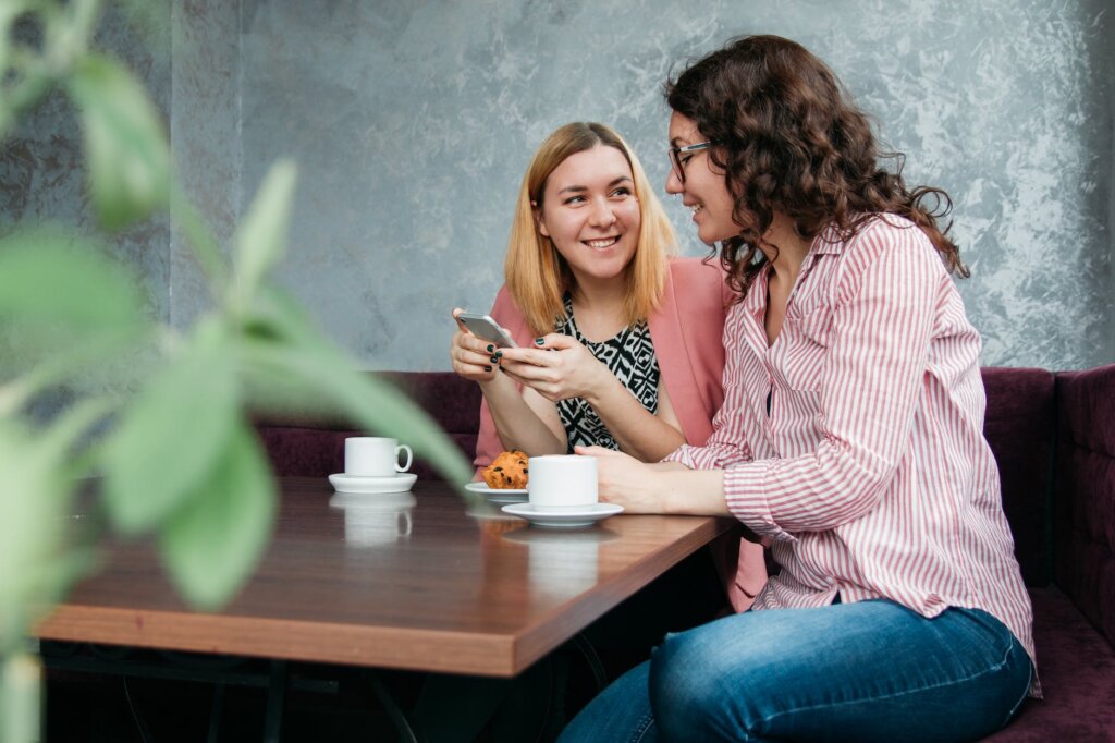 two women dining on brown wooden table